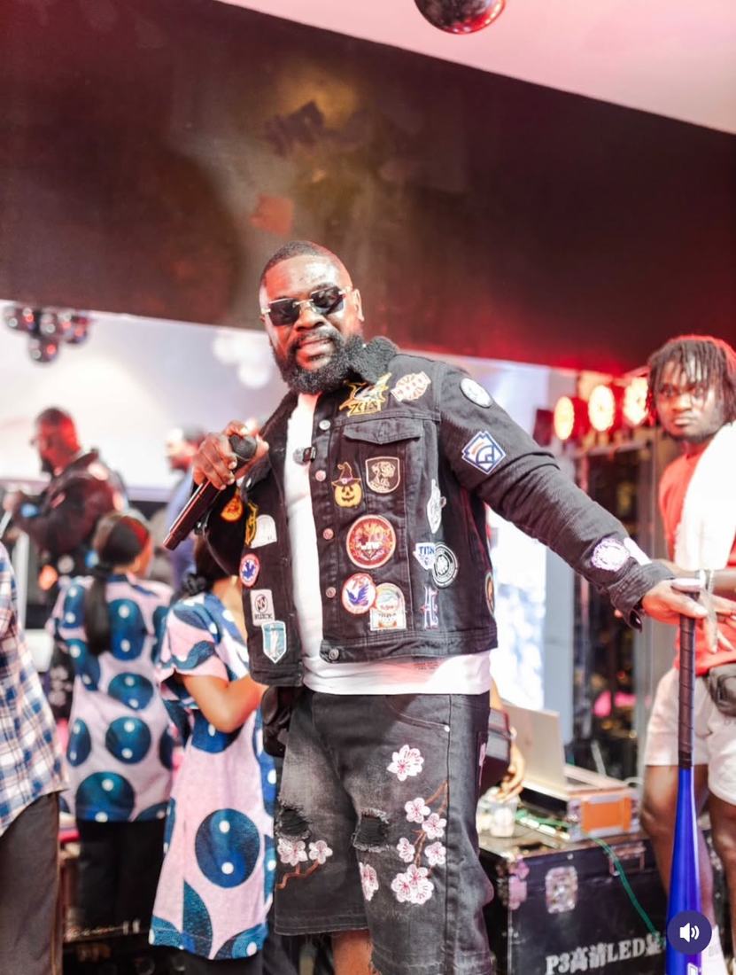 BK GMB performing live on stage with a microphone